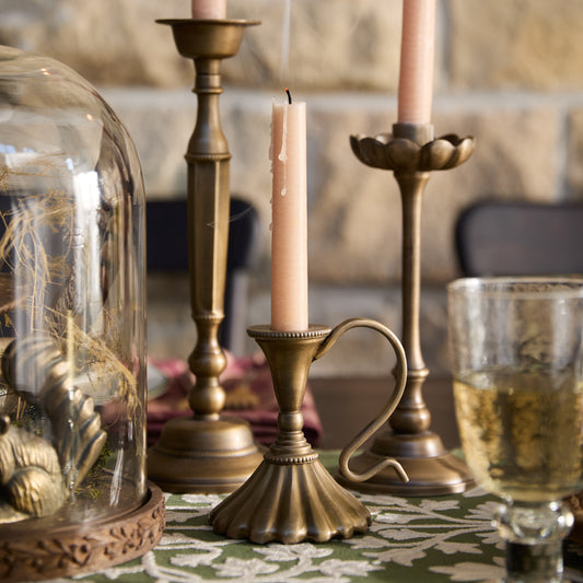 Anna Antique Brass Taper Holder on a dining table
