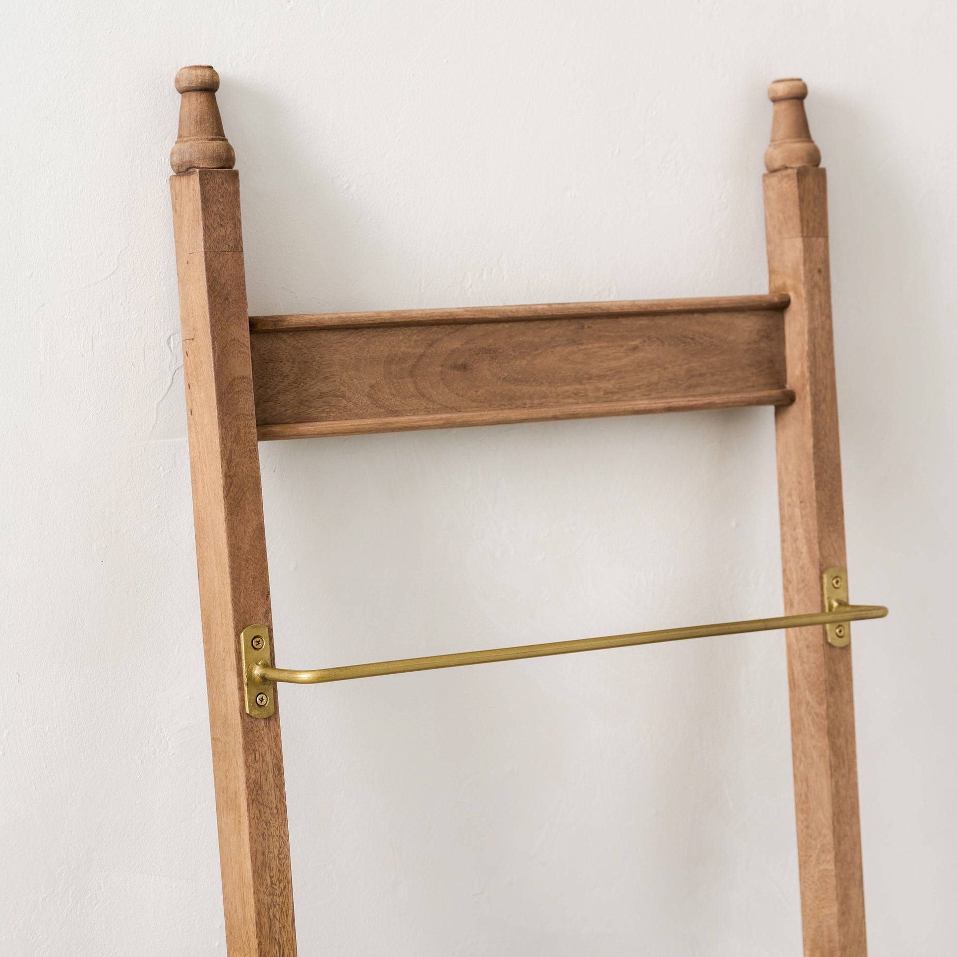 Brass and Wood Library Ladder against a wall - close up of top of ladder