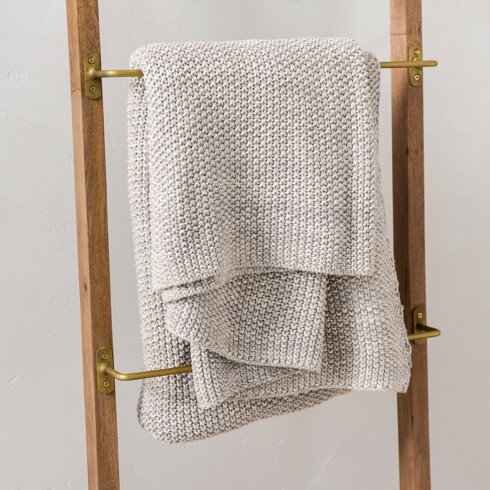 Brass and Wood Library Ladder close up of blanket hanging on ladder