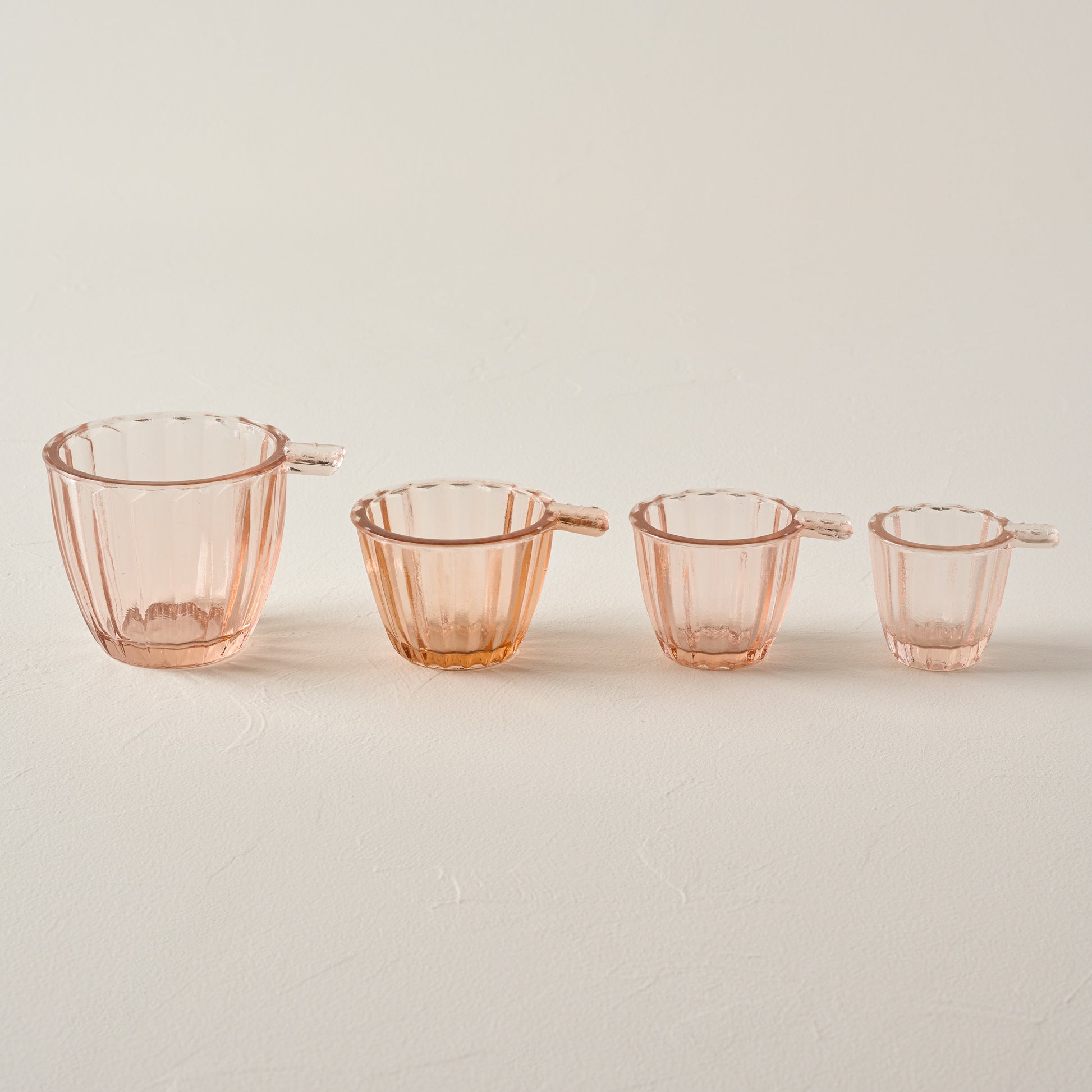 Blush Glass Measuring Cup Set in a line showing all four sizes