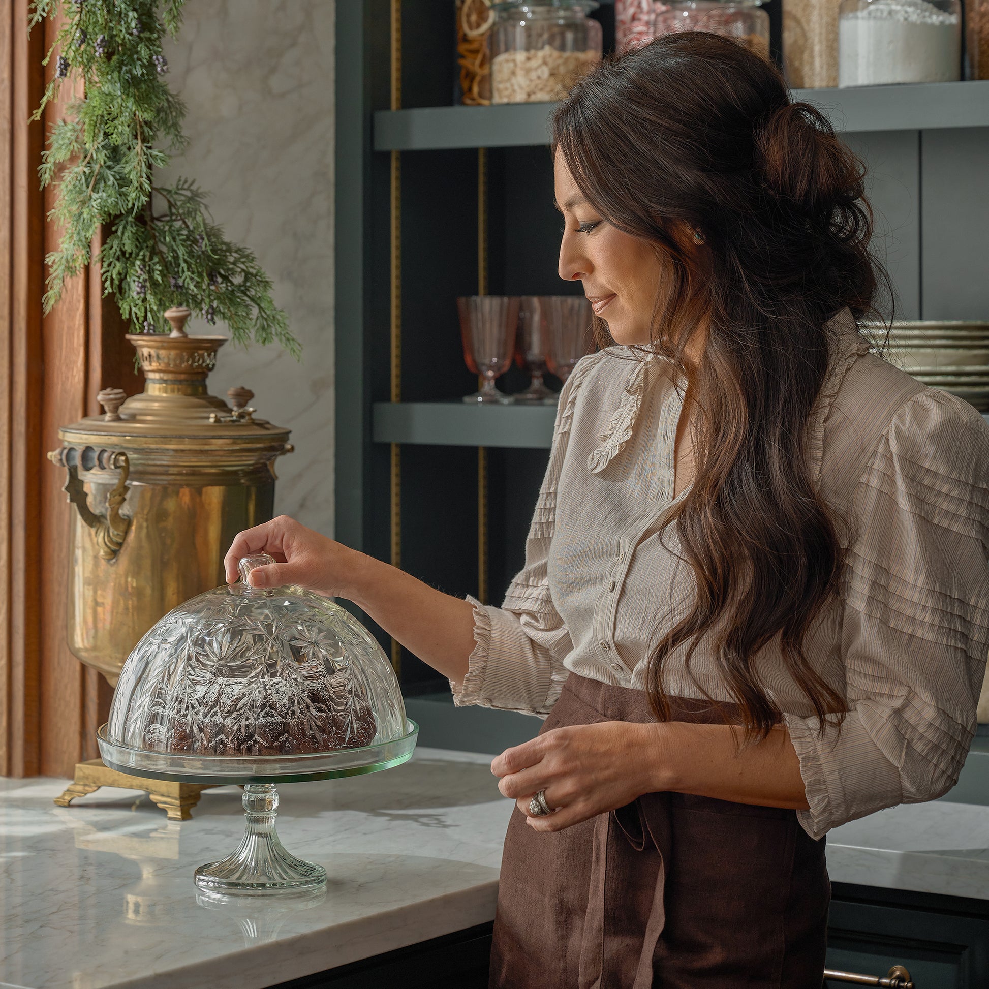 Joanna Gaines stands next to the Vivian Cut Glass Cake Stand in a kitchen
