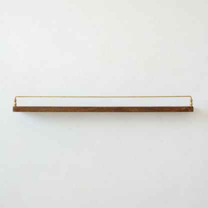 Elliott Wood and Brass Picture Ledge in large size hung on a wall