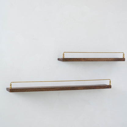 Elliott Wood and Brass Picture Ledge on both sizes hung on a wall