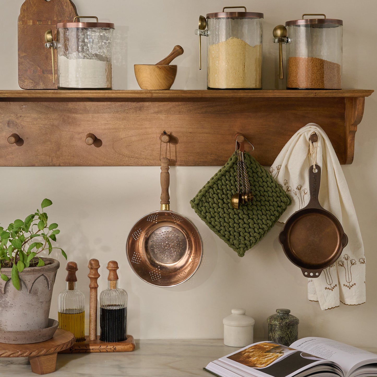 Hand Crocheted Cotton Pot Holder in Green shown hung on kitchen shelf