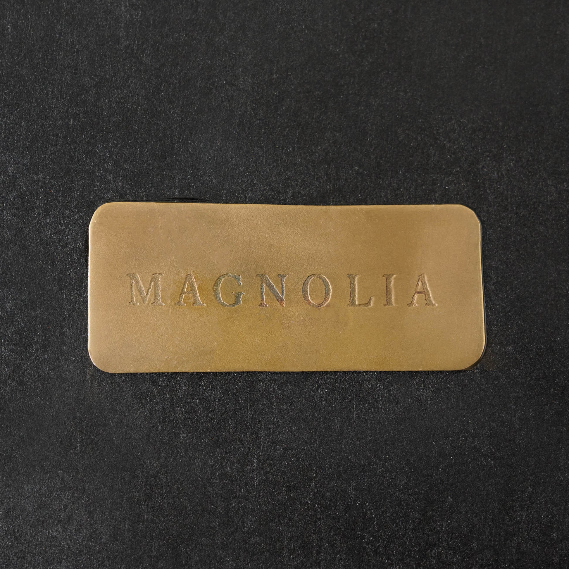 Gilded Wreath Mirrored Wall Sconce close up of magnolia logo on back 