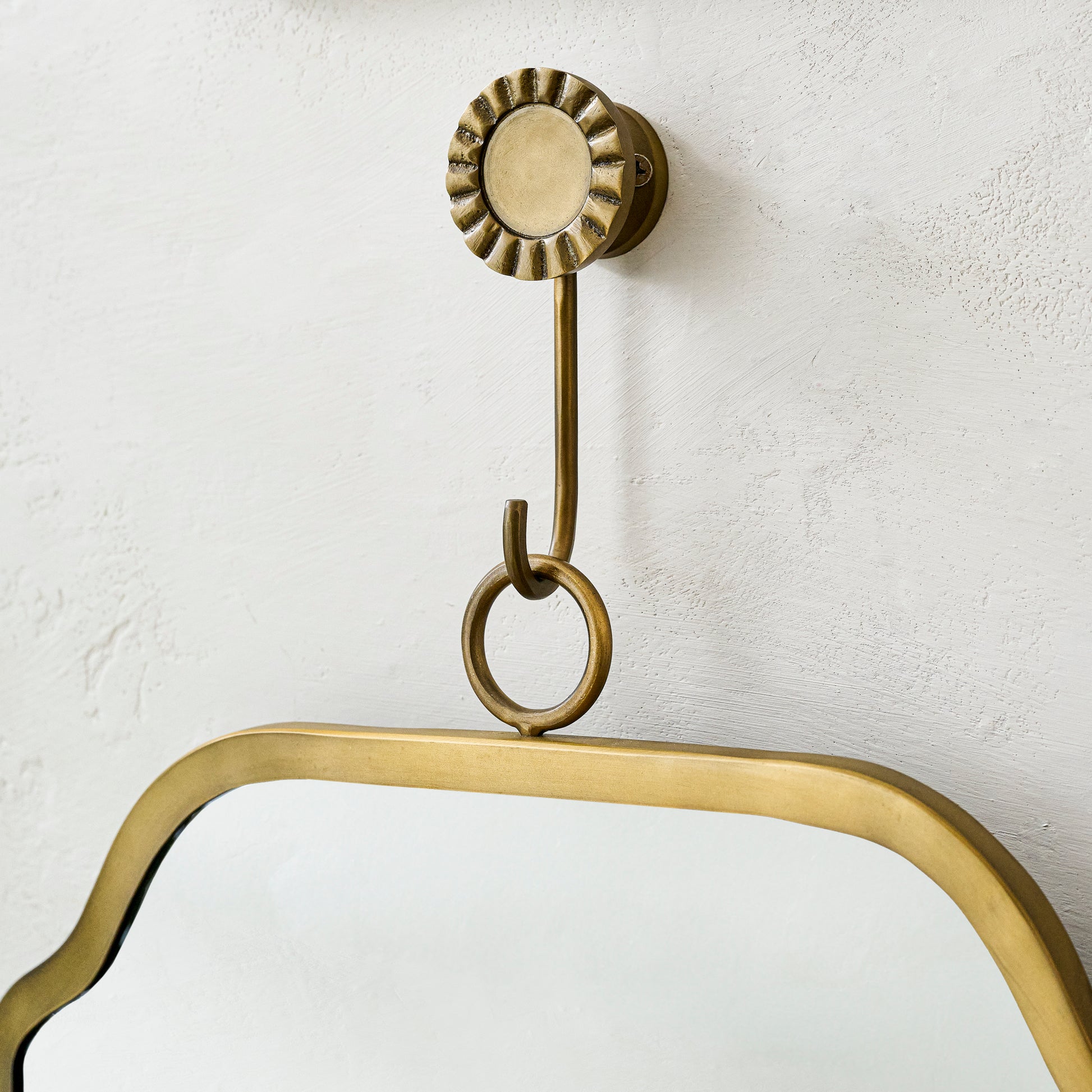 Justine Brass Hanging Mirror close up of hook holding mirror