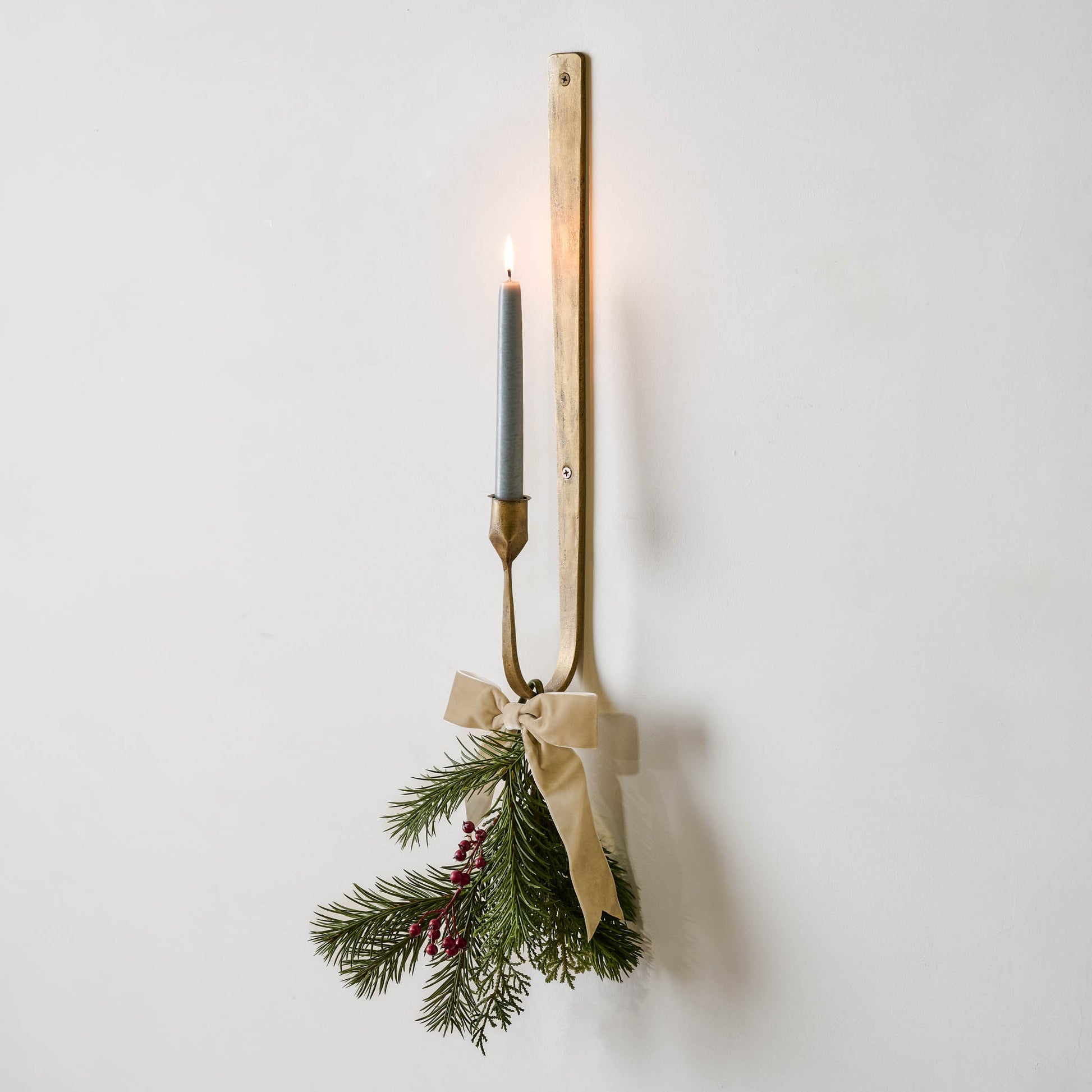 Julian Forged Iron Wall Sconce with holiday greenery