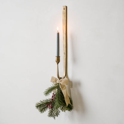 Julian Forged Iron Wall Sconce with holiday greenery