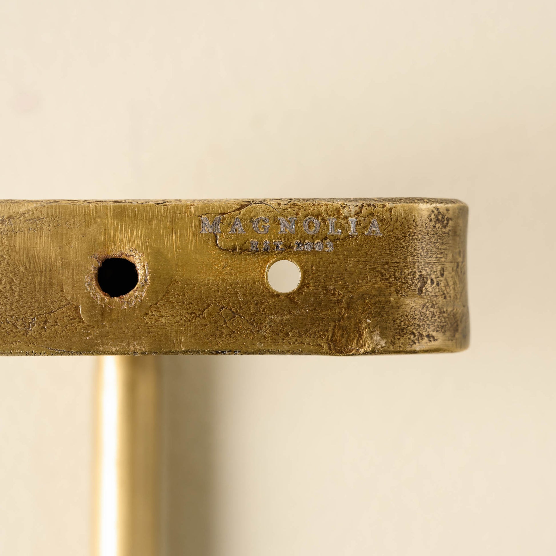 Duke Brass Rail with Hooks close up of magnolia logo on base