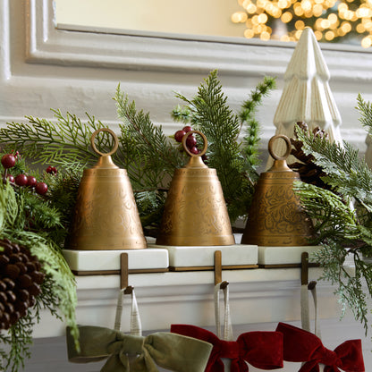 Antiqued Bell Stocking Holders on a mantle