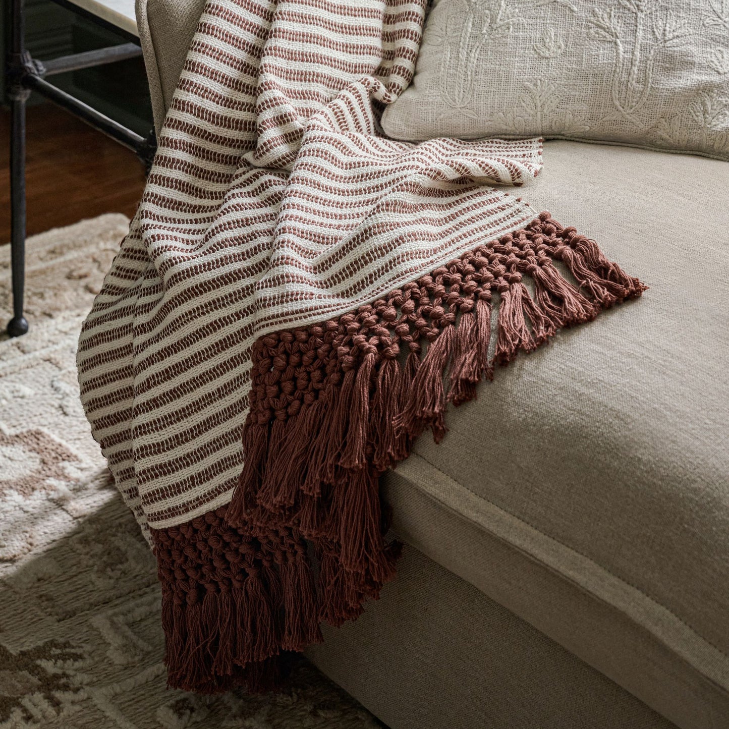 Essential Tassel Throw - Burgundy Striped shown draped over couch