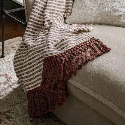 Essential Tassel Throw - Burgundy Striped shown draped over couch