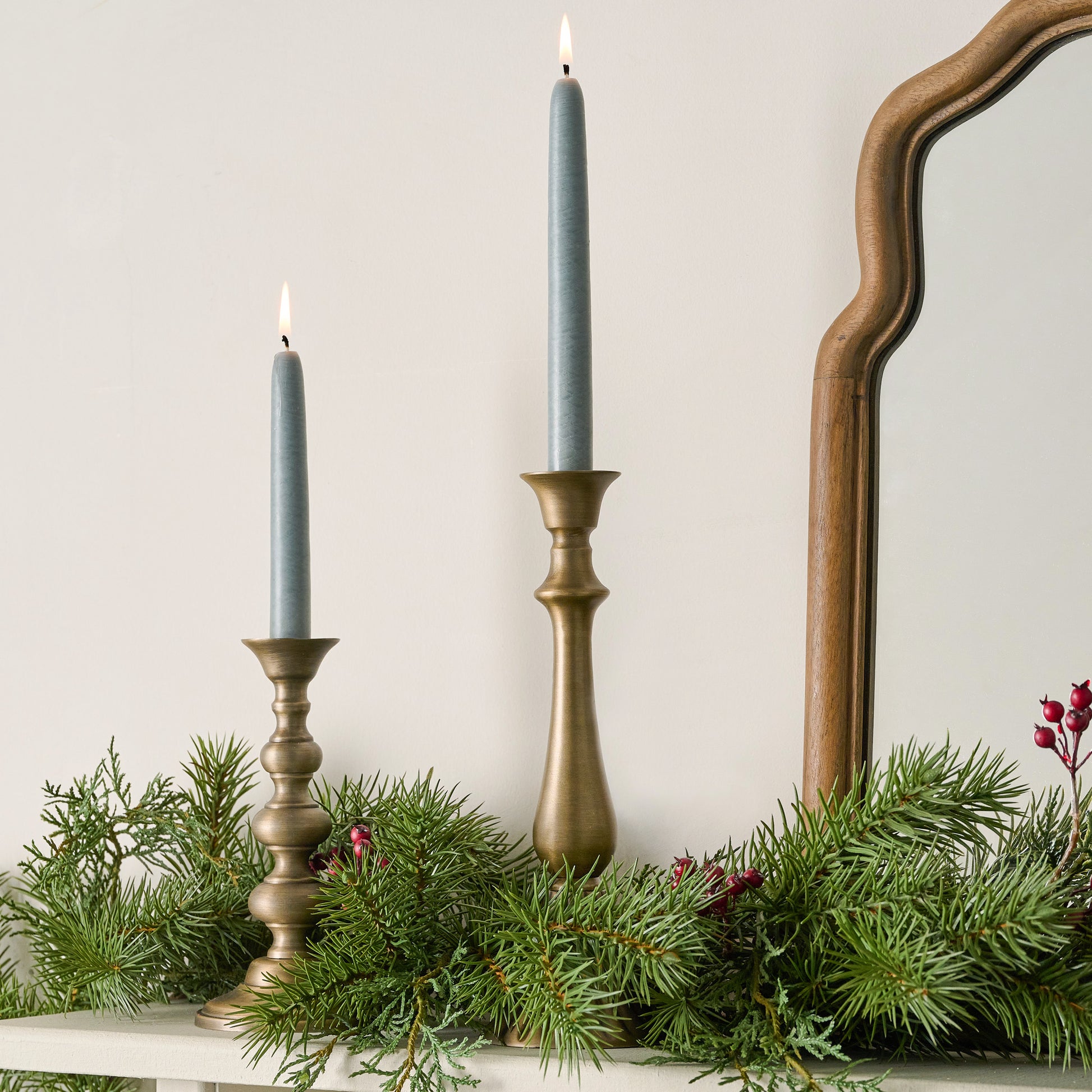 Faris Antiqued Brass Candleholders shown on mantel with candles