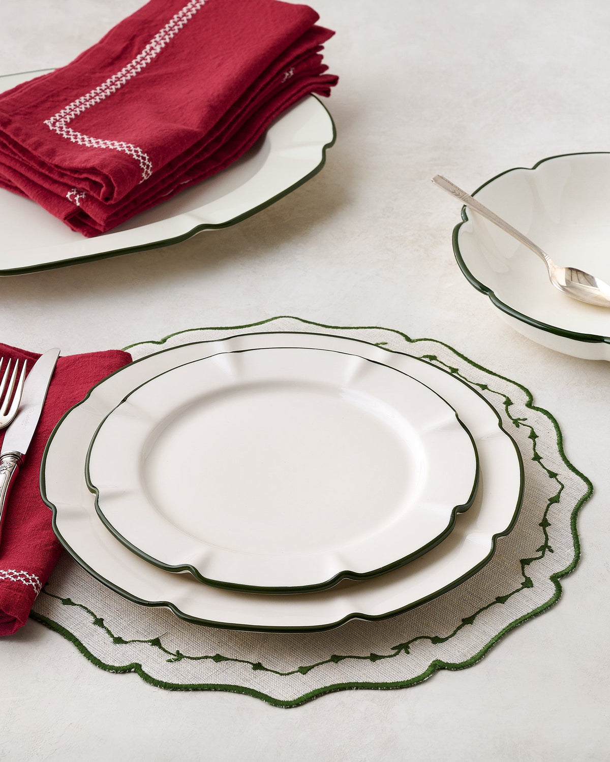 Green Luna Scalloped Plate shown with place setting and other Luna pieces
