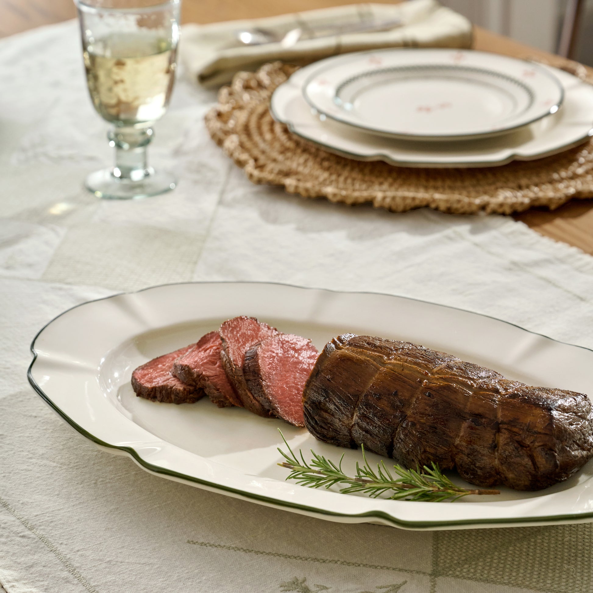 Green Luna Scalloped Serving Platter on a table