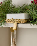 Marble and Gilded Stocking Holder shown on mantel
