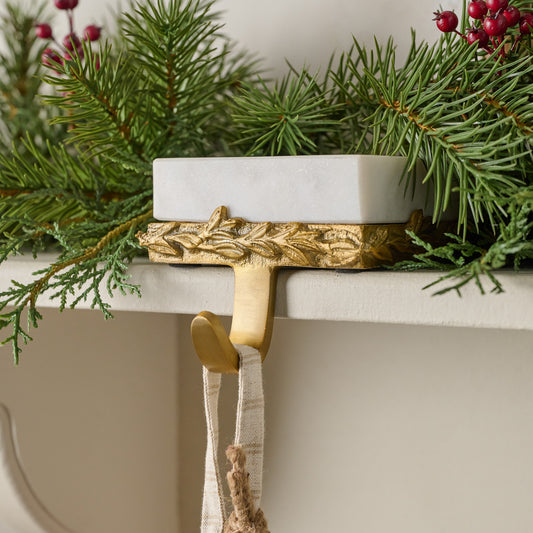 Marble and Gilded Stocking Holder shown on mantel