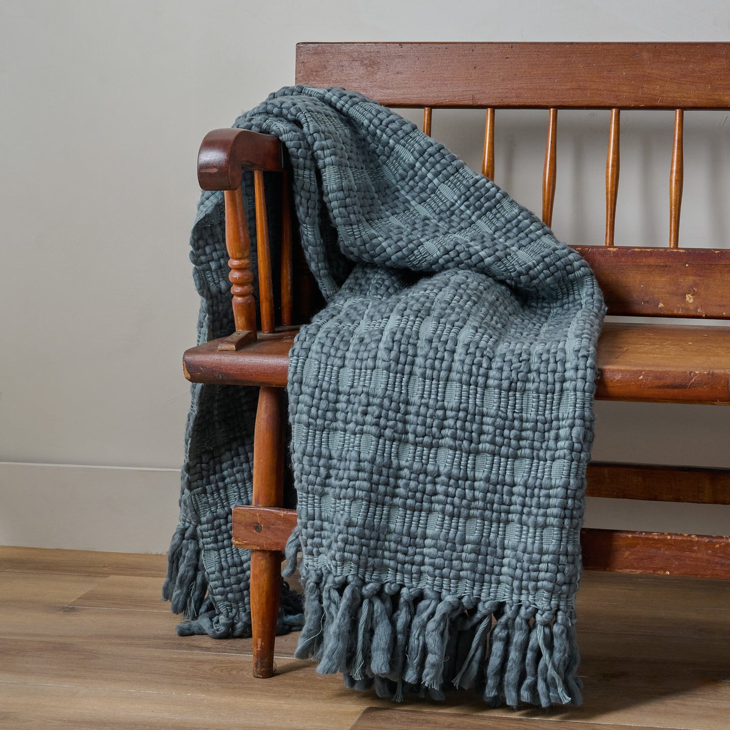 Haven Knit Throw in Twilight shown draped over bench