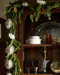 Real Touch Cedar Mix Oversized Garland - 100" on a cabinet