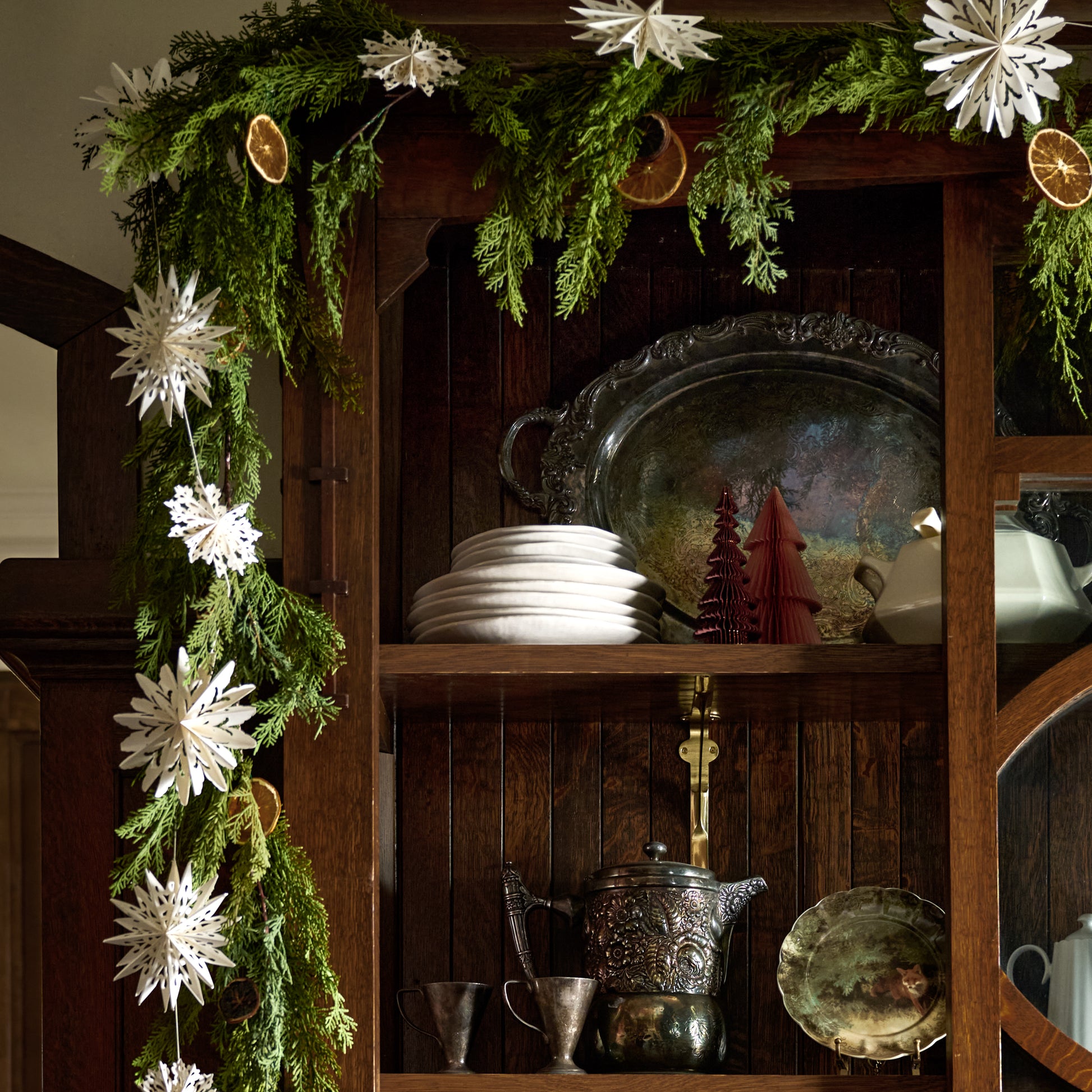 Whimsical Snowflake Garland on a cabinet