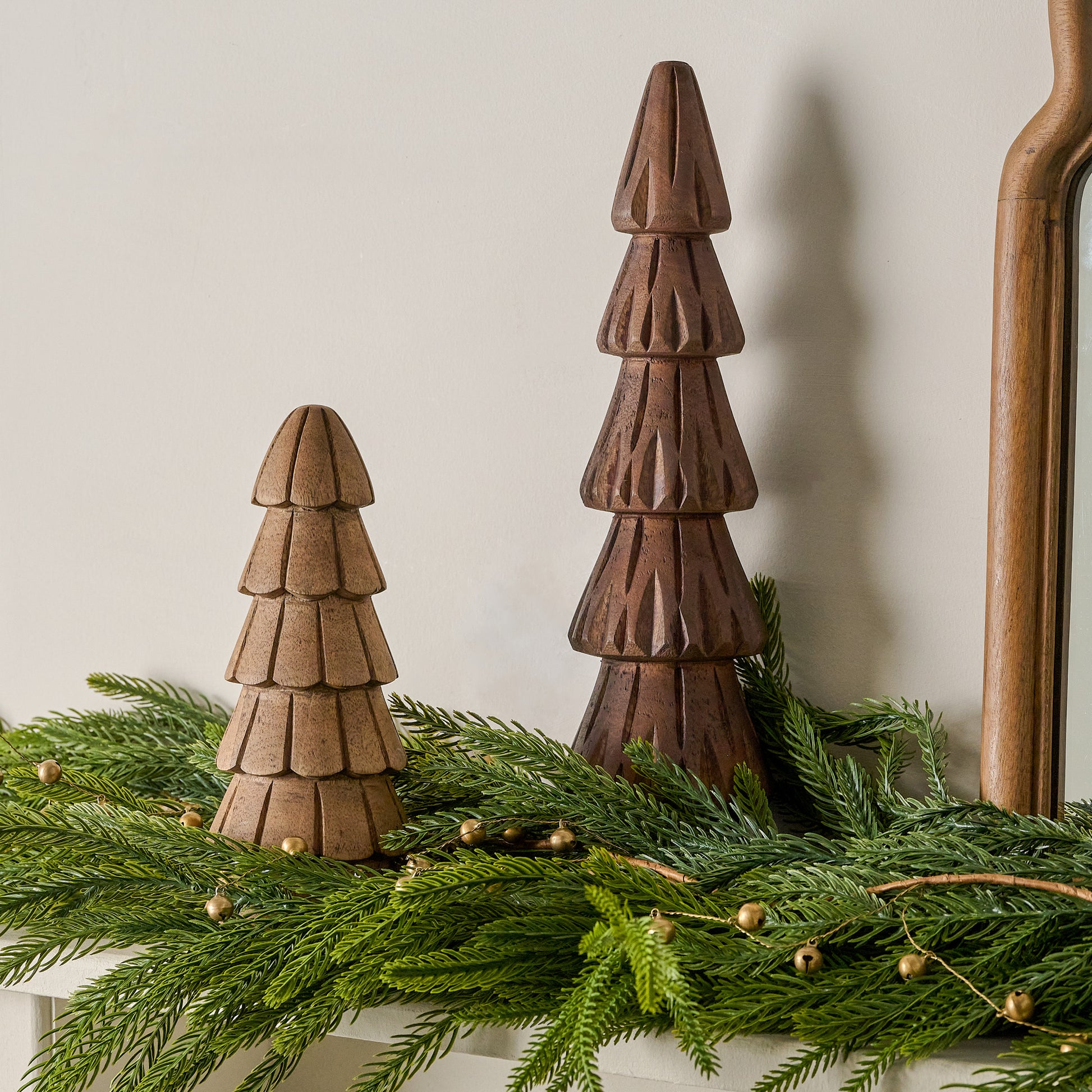 Hand Carved Woodland Trees shown on mantel with greenery