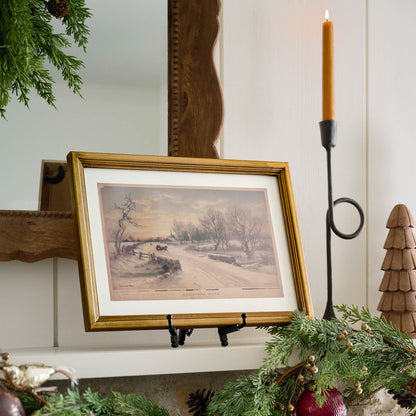 Vintage Christmas Morn Framed Print on a mantel
