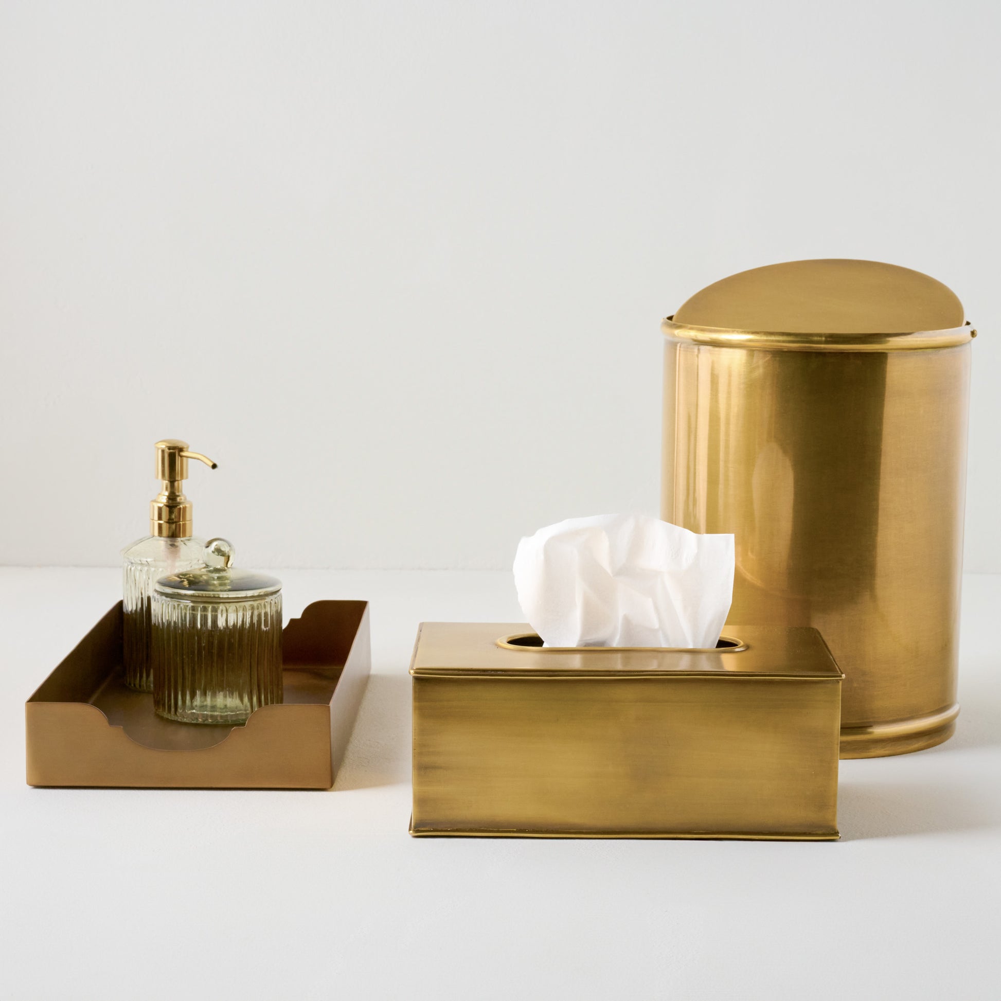 Antiqued Brass Swivel Top Waste Bin shown with other bath accessories
