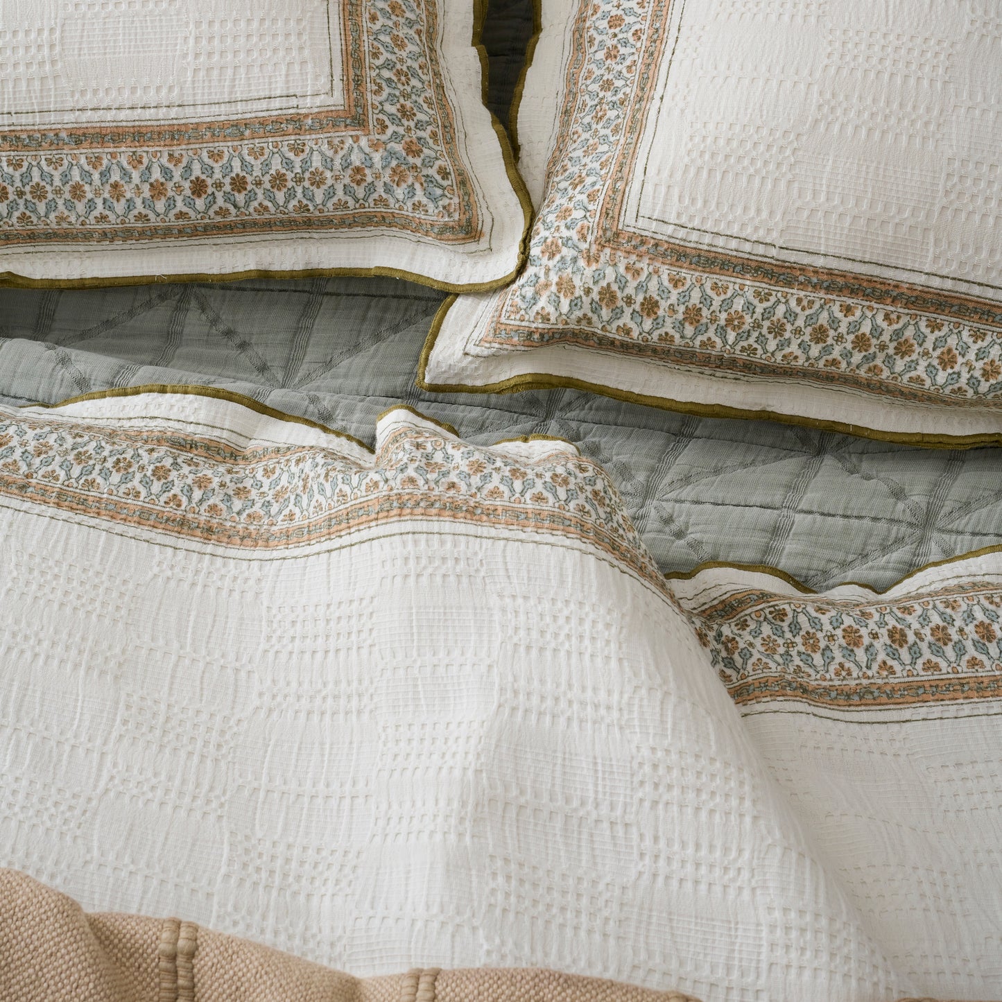 Clemence Block Print Sham shown on bed with duvet