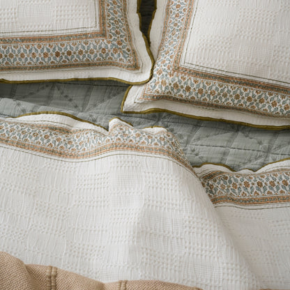 Clemence Block Print Sham shown on bed with duvet