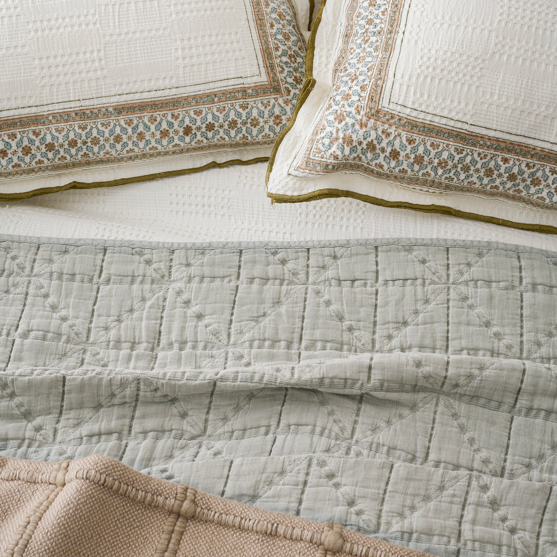 Sutton Stone Blue Matelasse Coverlet shown on bed