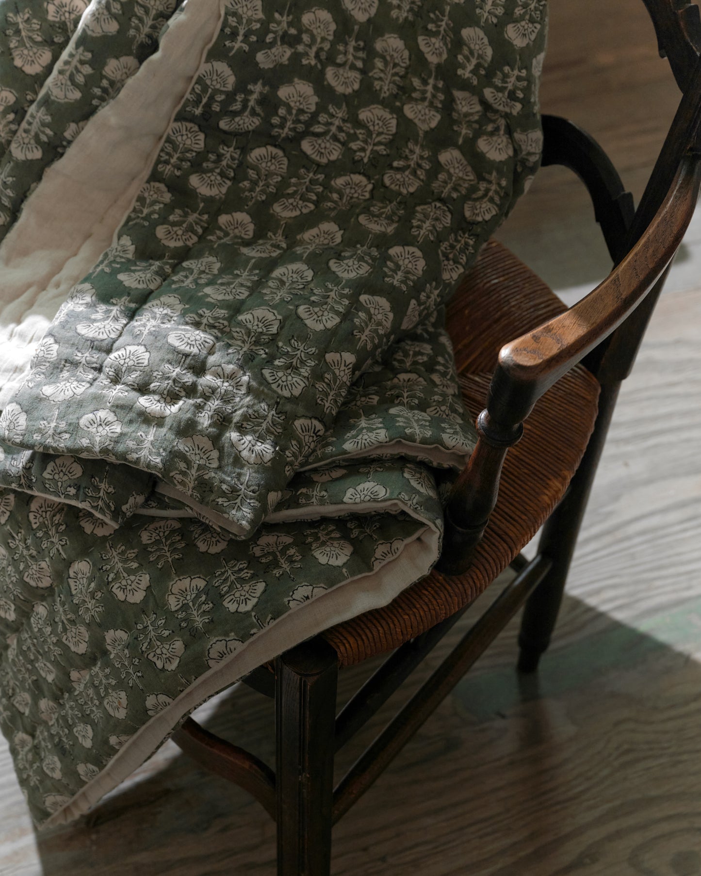 Flora Block Print Quilt - Dusty Green close up laying on chair
