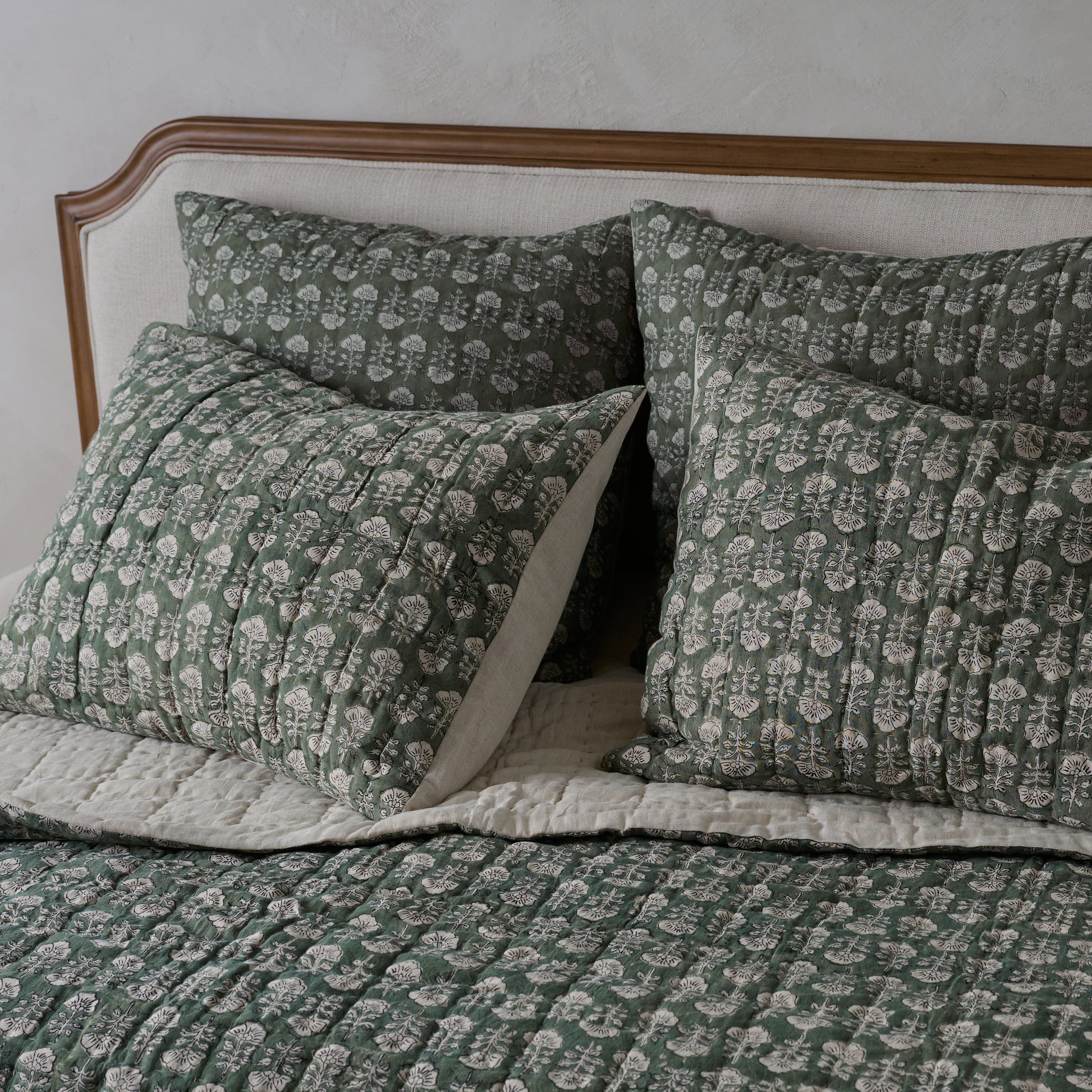 Flora Block Print Pillow Sham - Dusty Green shown on bed