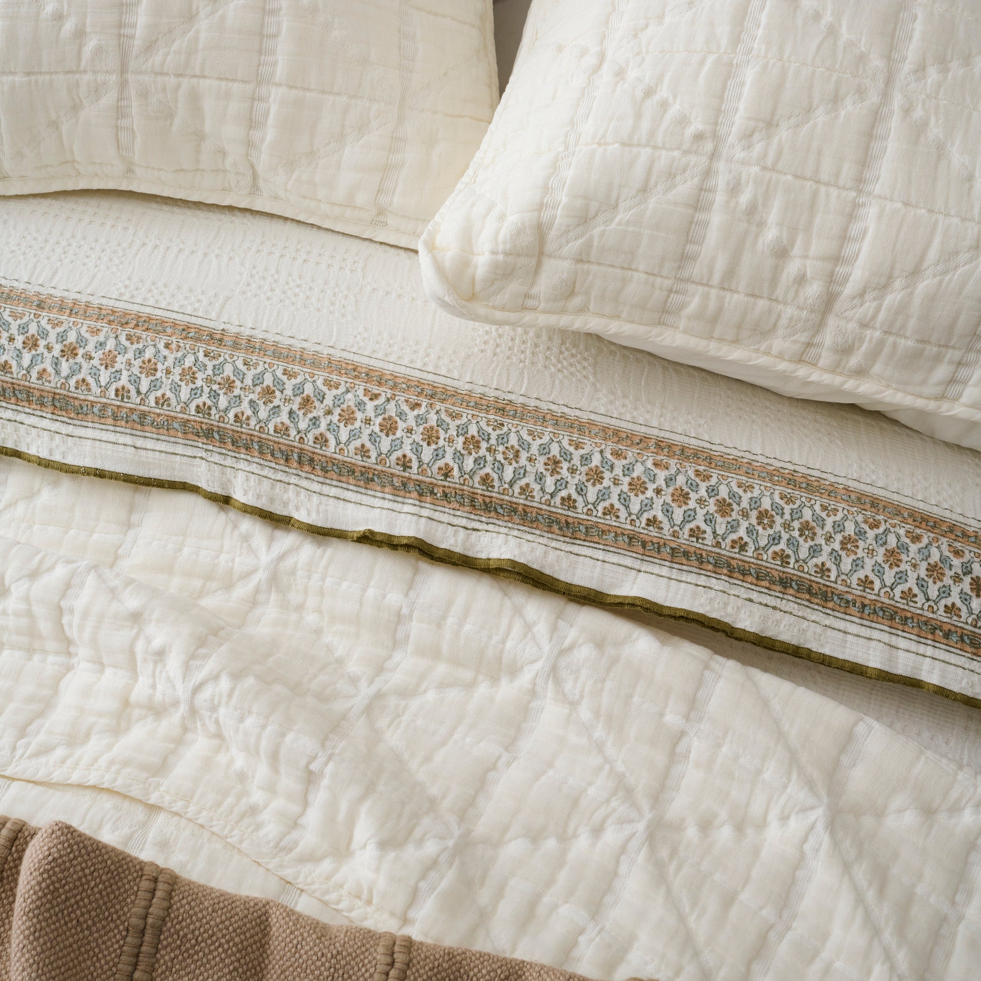 Sutton Cream Matelasse Sham shown on bed with quilt and other bedding