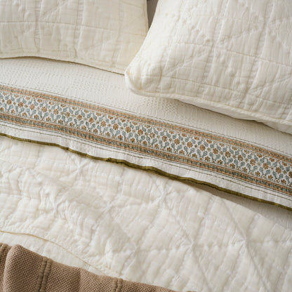Sutton Cream Matelasse Sham shown on bed with quilt and other bedding