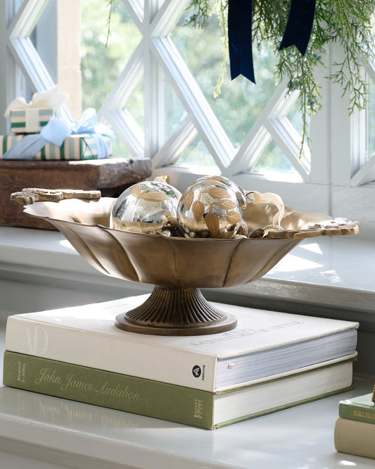 Oversized Ornate Brass Pedestal Bowl with ornaments in it