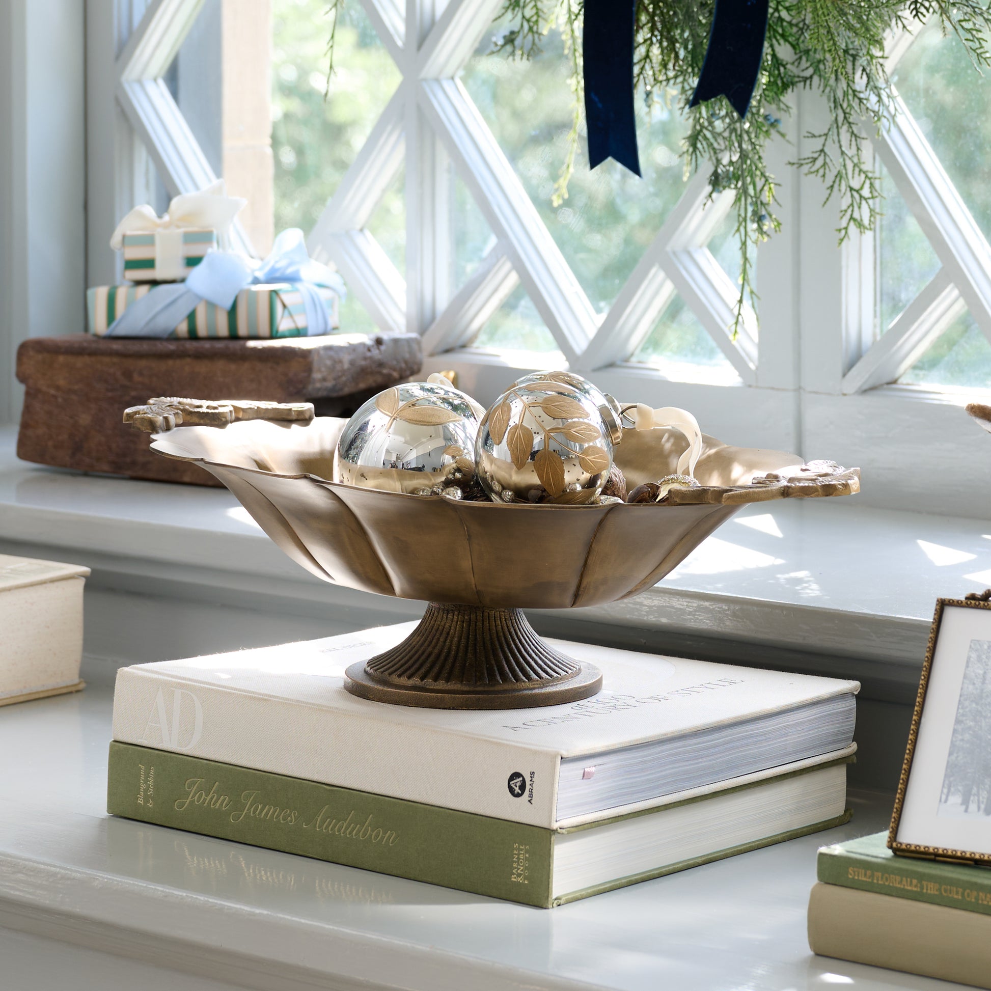 Oversized Ornate Brass Pedestal Bowl in a room