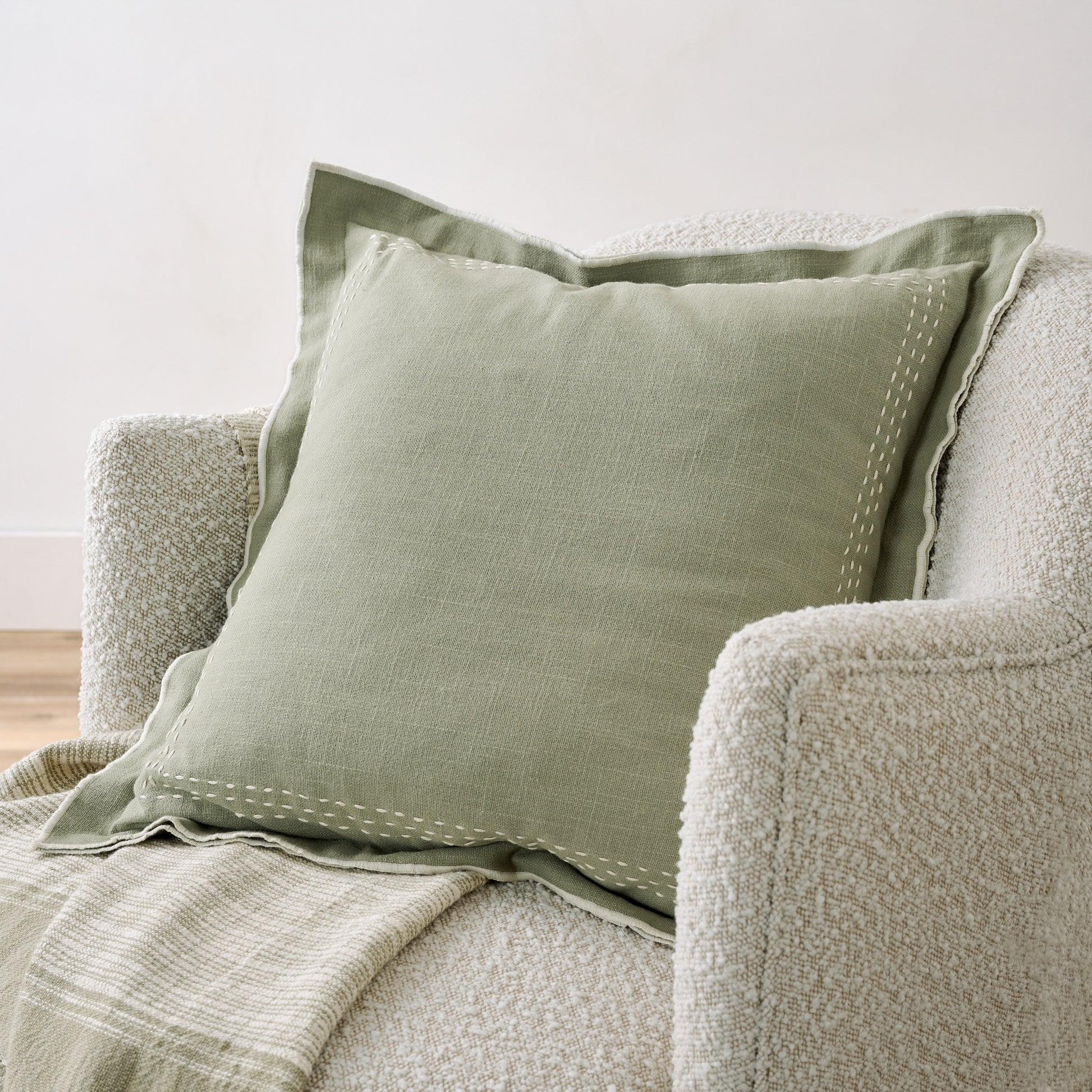 Seagrass Felix Embroidered Pillow show in chair