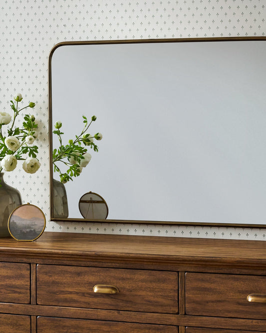 Collin Ribbed Brass Mantel Mirror in a room