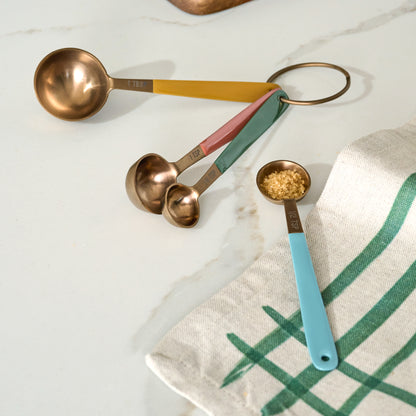 Evie Copper Measuring Spoons shown on kitchen countertop