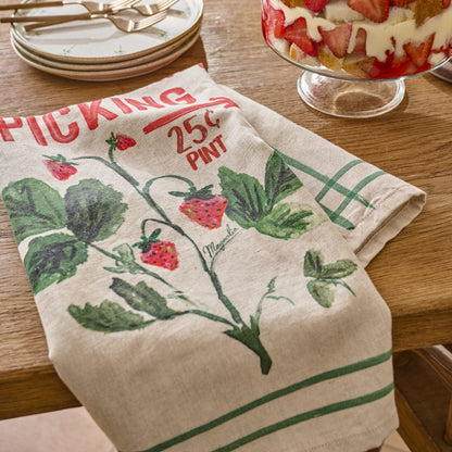 Magnolia Strawberry Picking Tea Towel shown on dining table