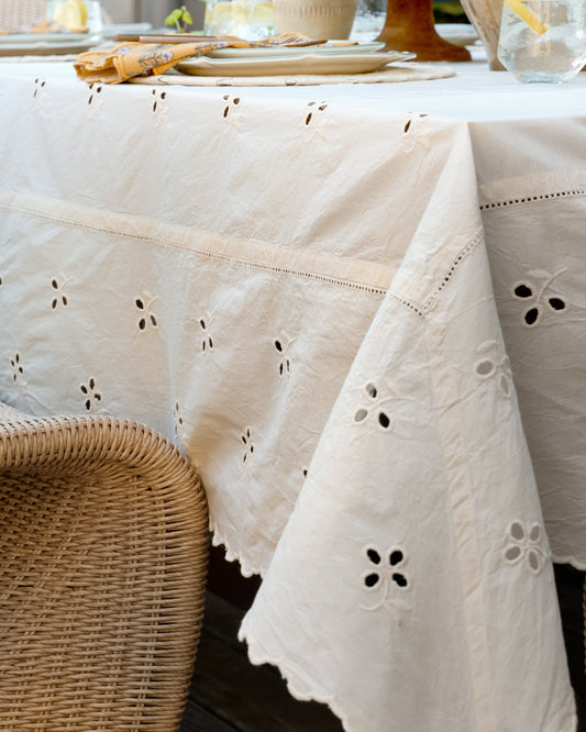Antique White Eyelet Tablecloth up close shown on table outside