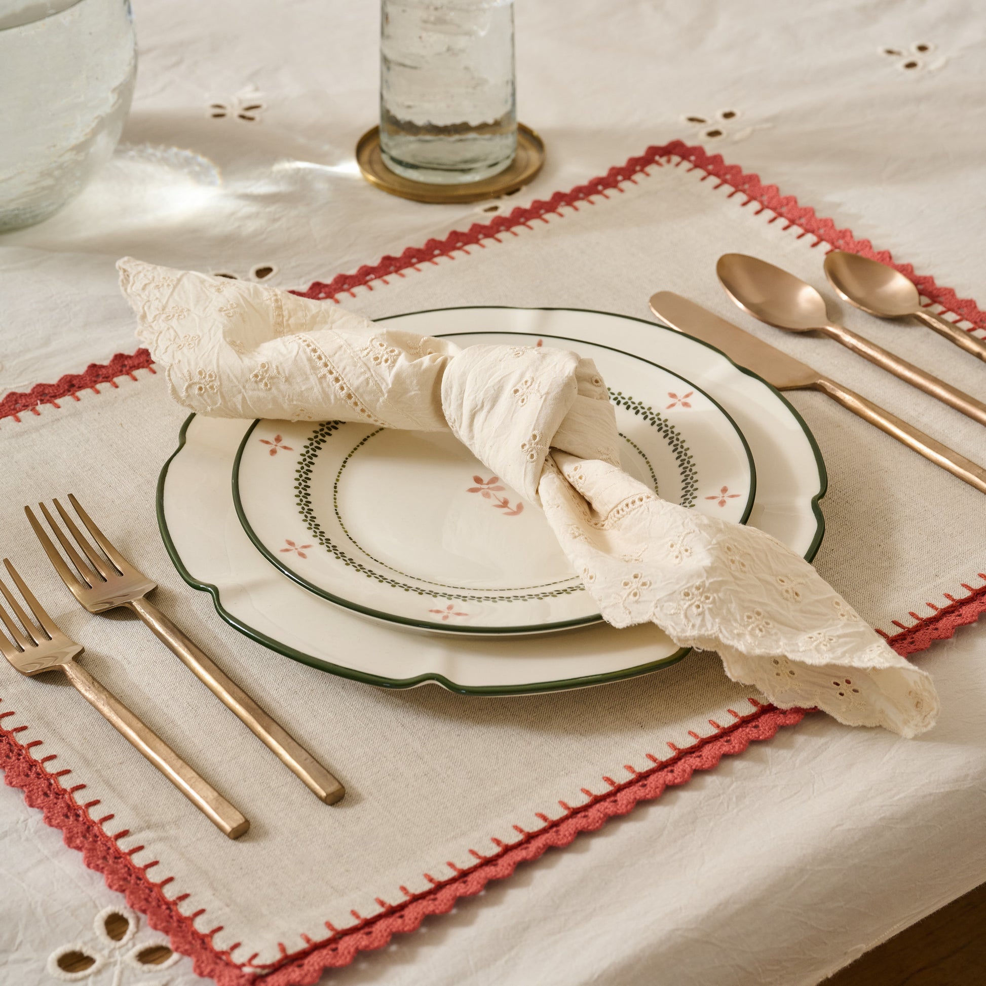 Antique White Eyelet Napkin knotted on a place setting