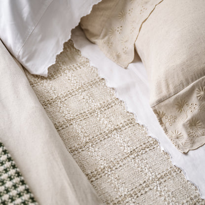 Natural Woven Grid Coverlet on a bed