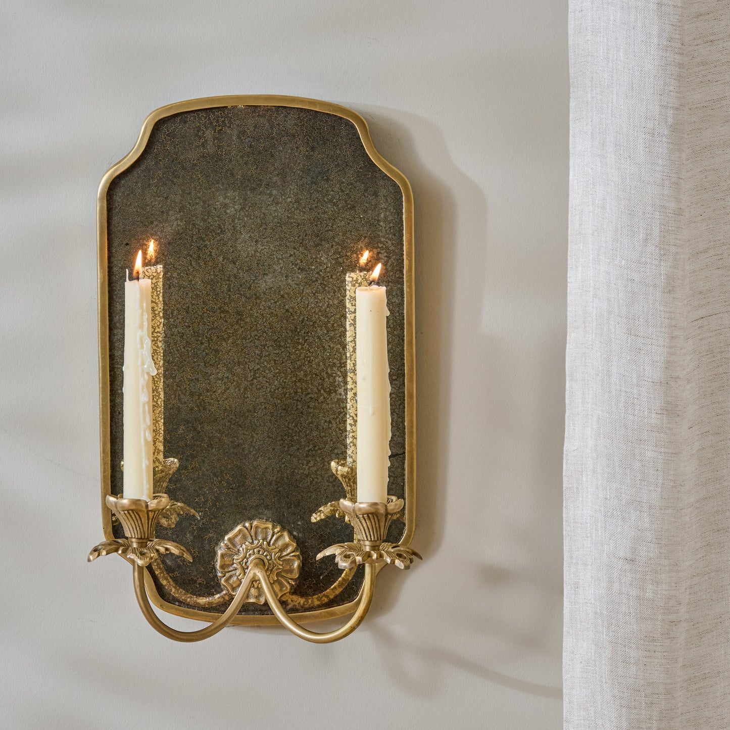 Maven Mirrored Double Wall Sconce shown styled with taper candles