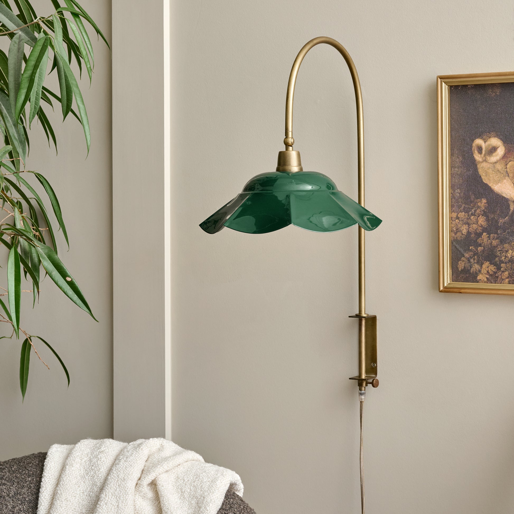 Mary Enamel Plug-in Sconce Dark Green with Brass shown on wall