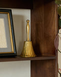 Marie Fluted Brass Bell shown on shelf