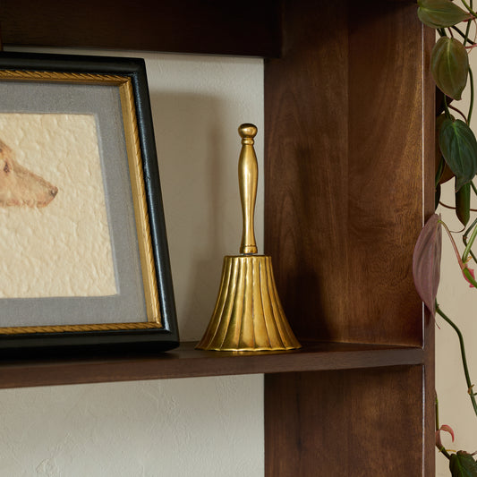 Marie Fluted Brass Bell shown on shelf