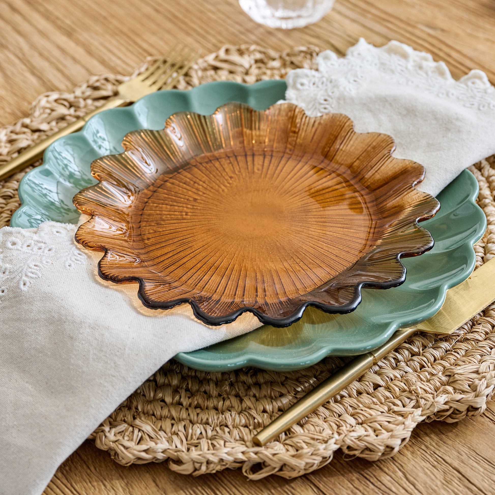 Emmeline Amber Scalloped Glass Plate shown on table