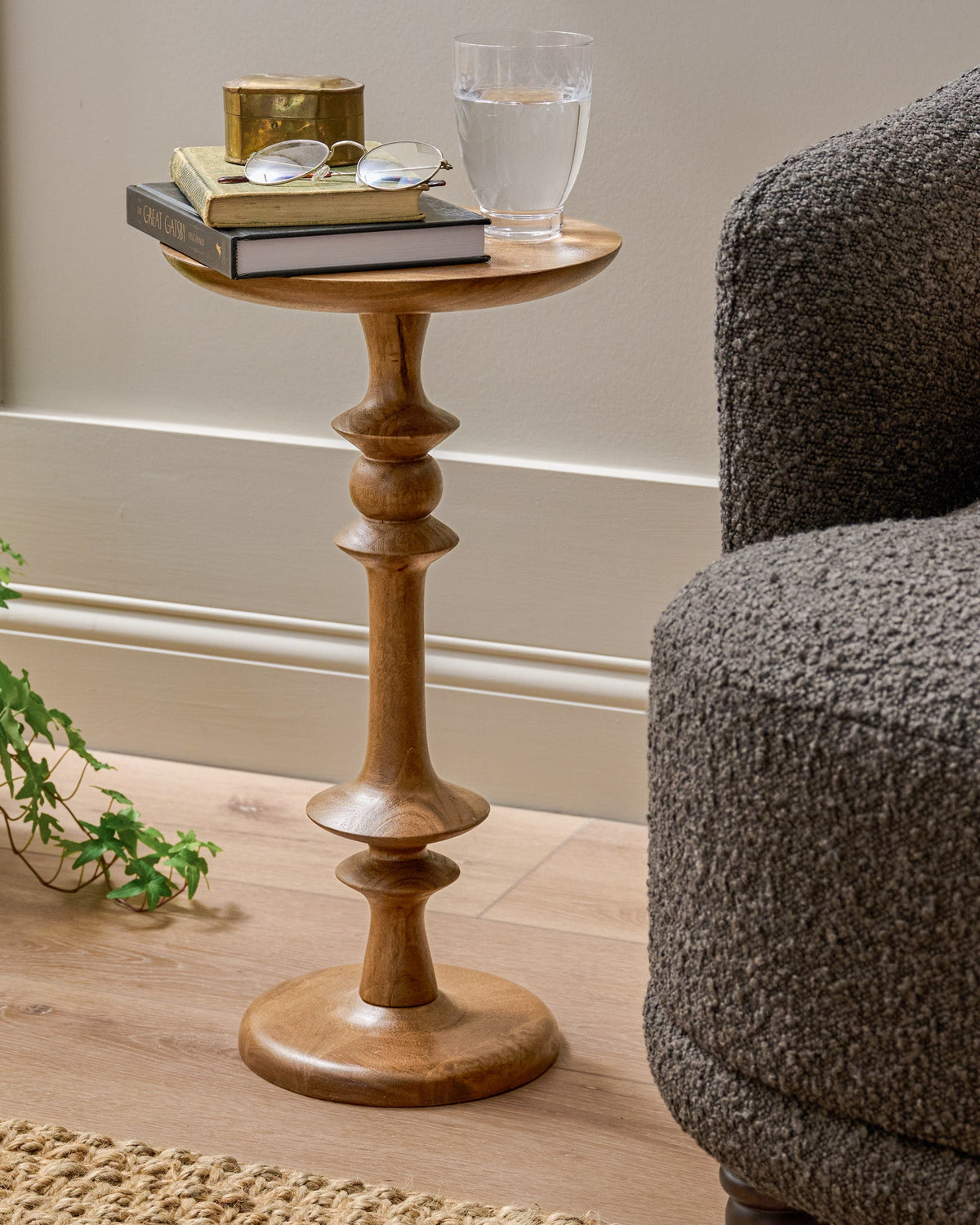 Enzo Turned Wood Cocktail Table in Honey Mango shown next to accent chair