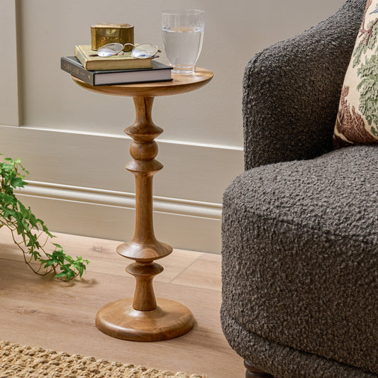 Enzo Turned Wood Cocktail Table in Honey Mango shown next to accent chair
